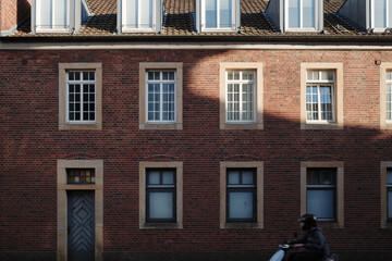  A classic red brick building with symmetrical windows framed in stone.