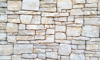 Fototapeta premium High resolution stone wall texture background with natural patterns and rugged details. Perfect for backdrop wallpaper, architectural designs, and rustic aesthetics.