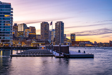 View of Boston downtown  skyscrapers seen from Seaport District on a cold cloudy winter evening