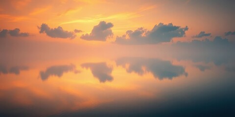 Fototapeta premium Misty sunrise paints a serene lake with warm orange hues, reflecting clouds in still water, stock, hour