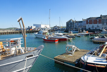 Sighseeing boats and trawlers in the serene harbour in Padstow, Cornwall