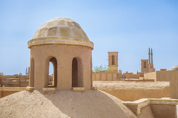 View of rooftops of old city of Yazd, Iran. In foreground is ventilation dome. Such structures have...