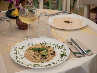 Mushroom risotto served with white wine at the restaurant