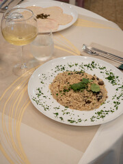 Mushroom risotto with parsley and white wine served at restaurant