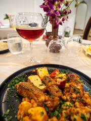 Enjoying spicy sausages and potatoes with red wine at restaurant