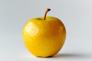A close-up of a golden apple with a natural sheen, photographed on a plain white background.