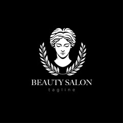 Silhouette of a woman's face surrounded by leaves. Logo for beauty salon on a black background