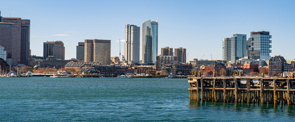 View of Boston skyline and skyscrapers in February winter seen from Piers Park in Boston, MA
