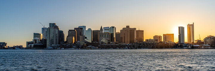 View of Boston skyline and skyscrapers in late evening of February winter seen from Piers Park in Boston, MA