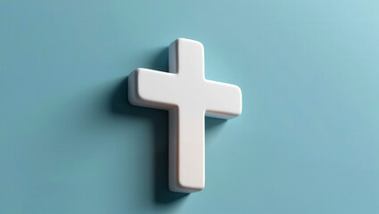 Obraz premium A minimalist white cross mounted against a soft blue background, symbolizing faith and spirituality.