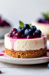 Blueberry topped cheesecake with graham cracker crust and fresh berry sauce