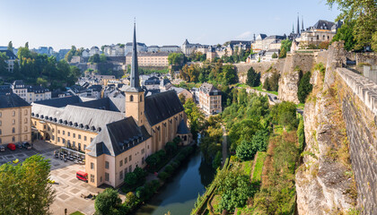 Panoramic view of the Alzette valley in Luxembourg City, Luxembourg, with the Neim&euml;nster Abbey and Grund district on the left overlooked by the Ville-Haute district, the old town, on a sunny day.