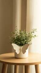 Elegant Butterfly-Inspired Ceramic Plant Pot on Wooden Table with Greenery - Modern Home Decor Concept