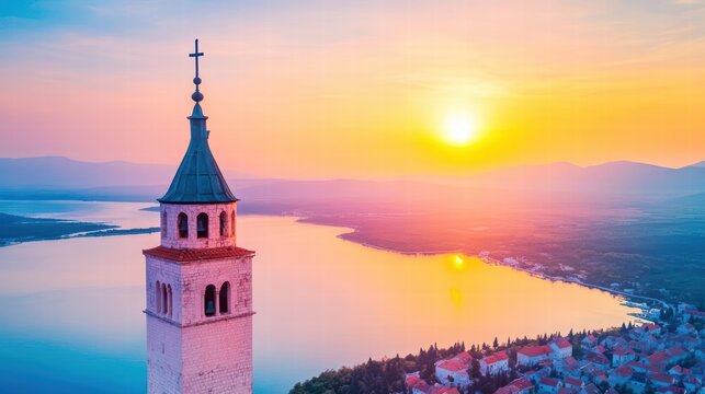 Aerial view of selce church tower majestically rising in the center of a serene lake surrounded by lush greenery
