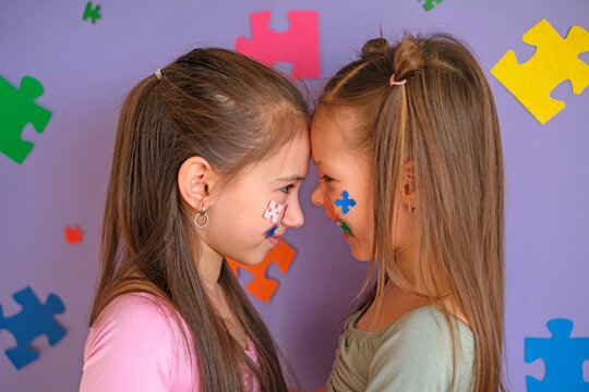 ASD, autism spectrum disorder awareness concept. Laughing children stand face to face, supporting and loving each other despite illness.
