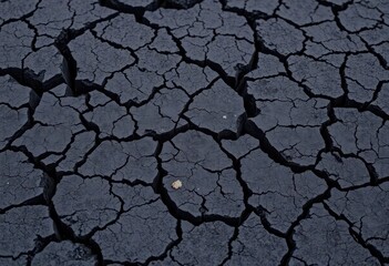 Rough, black volcanic rock with deep cracks, textured lava surface, nature, background