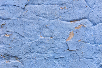 Blue concrete wall texture closeup, wall with cracked paint and rough surface. Concrete wall background perfect for design. Concept of vintage textured wall for stylish backgrounds and designs