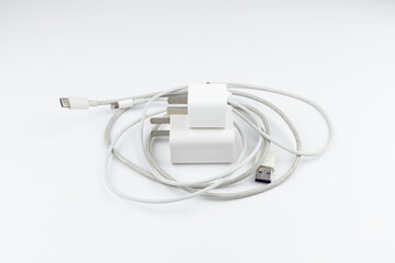 New and old mobile phone chargers on white background