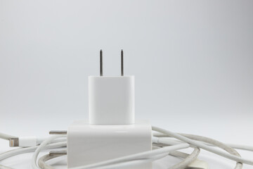 New and old mobile phone chargers on white background