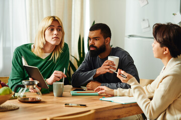 Young diverse men engage in lively discussions at a cozy book club meeting in their modern home