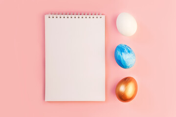 List or note isolated with set of colorful eggs. Spring trendy composition on yellow background. Easter holiday concept. Flat lay, top view, place for text. Greeting card, notebook, frame, mock up