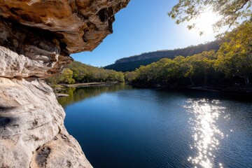 Obraz premium This serene landscape showcases a tranquil river, reflecting natural beauty and sunlight, surrounded by lush trees, inviting relaxation and peaceful contemplation in nature.