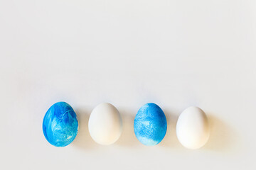 Easter frame with blue and white color eggs isolated on gray background. Stylish trendy minimal set or composition with natural painted egg. Flat lay, top view, place for text. Happy egg hunt concept