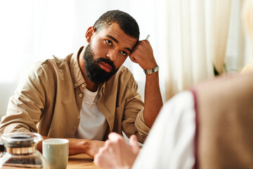 Engaging young men bond over books in a cozy home setting at their reading club