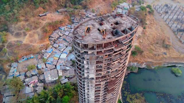 Aerial view forsaken tower with cranes atop