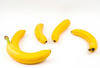 Four plump, yellow bananas on a pristine white background, multiple, isolated