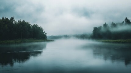 Ethereal river scene: Fog rolling over still water reflecting forested banks
