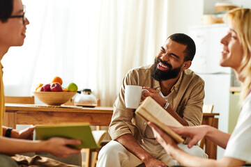Engaging conversation among young men in a cozy book club setting at home