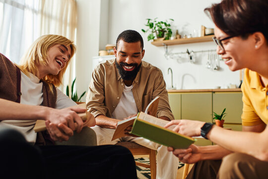 Young diverse men sharing ideas and laughter at a cozy book club gathering in a modern home setting