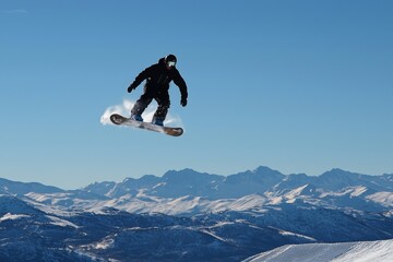 A snowboarder is performing highly dangerous aerial maneuvers