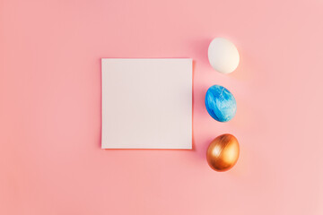 List or note isolated with set colorful eggs. Spring trendy composition on pastel pink background. Easter holiday concept. Flat lay, top view, place for text. Greeting card, notebook, frame, mock up