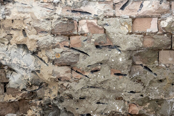 Old exterior brick wall. Old destroyed wall structure in vintage style. Abstract background texture texture. Old exterior wall. Abstract wall with painted grunge background.