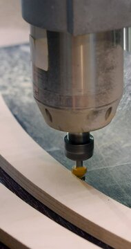 Furniture manufacturing. Detail processing close-up. The master's hands work with a furniture detail on a milling machine. A master crafts furniture detail with expert hands and care.