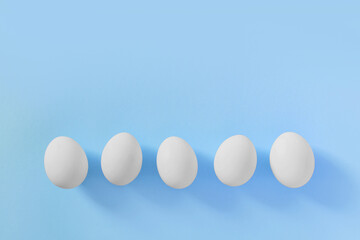 Frame of Easter white natural eggs set isolated on pastel pink background. Stylish trendy composition with chicken egg. Flat lay, top view, place for text. Happy eco-friendly holiday, minimal concept