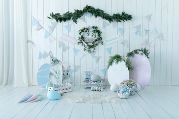 Colorful Easter room interior design with decorative figurine bunny. Baskets with lot colorful...