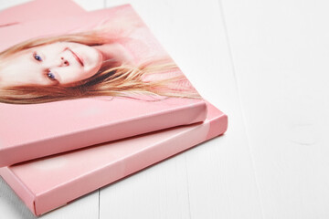 Two stacked canvas prints featuring a smiling young girl in soft pink tones. Printed on...