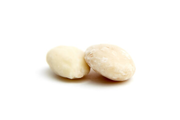 Close-up of two blanched almonds with smooth, pale textures, isolated on a white background. Perfect for healthy eating and nutrition themes