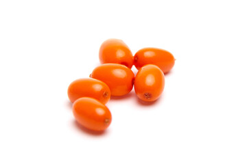 A small group of bright orange sea buckthorn berries with a smooth, glossy texture, scattered on a white background. Rich in nutrients, commonly used in health foods