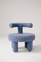 Blue bouclé armchair on white background