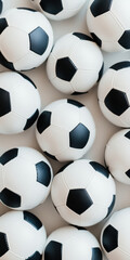 Cluster of classic black and white soccer balls in a neat arrangement on a white surface