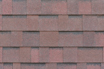 Red-brown asphalt shingles, close-up texture
