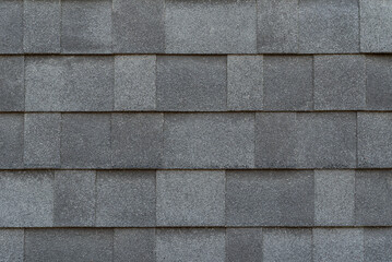 Overlapping sheet of soft gray asphalt shingles