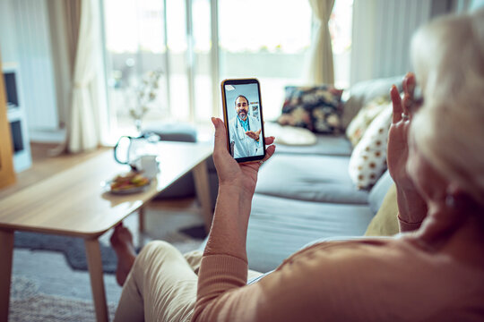 Senior woman having video call with doctor from home