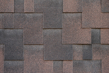 Dark bitumen shingles with a brown tint, laid with an overlap