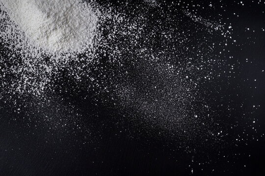 White Flour Scattered on Black Background