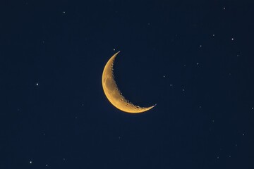 Naklejka premium Crescent Moon Illuminates Night Sky Surrounded by Stars in Deep Blue Background